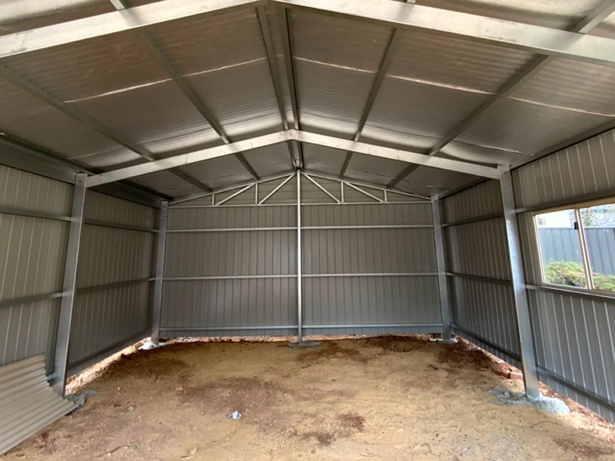A bare steel shed before we start
